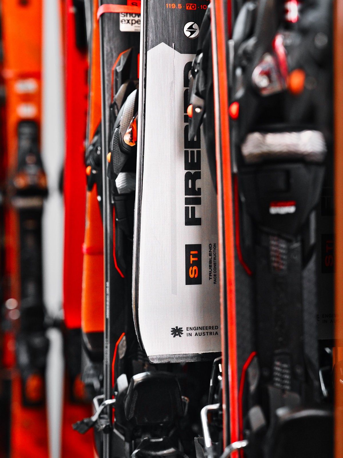 Dynamische Imagefotografie moderner Ski im Verleihsystem, sportliches Detail im Outdoor Store für Wintersport Branding