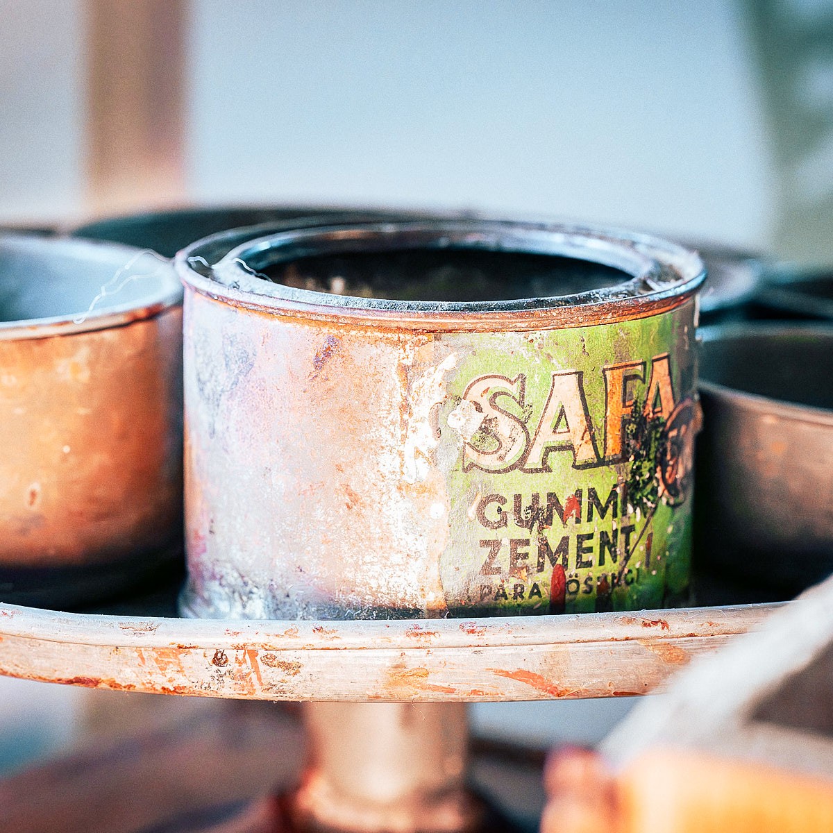 Artistic detail photography of tools and materials in traditional craftsmanship workshop with authentic atmosphere.